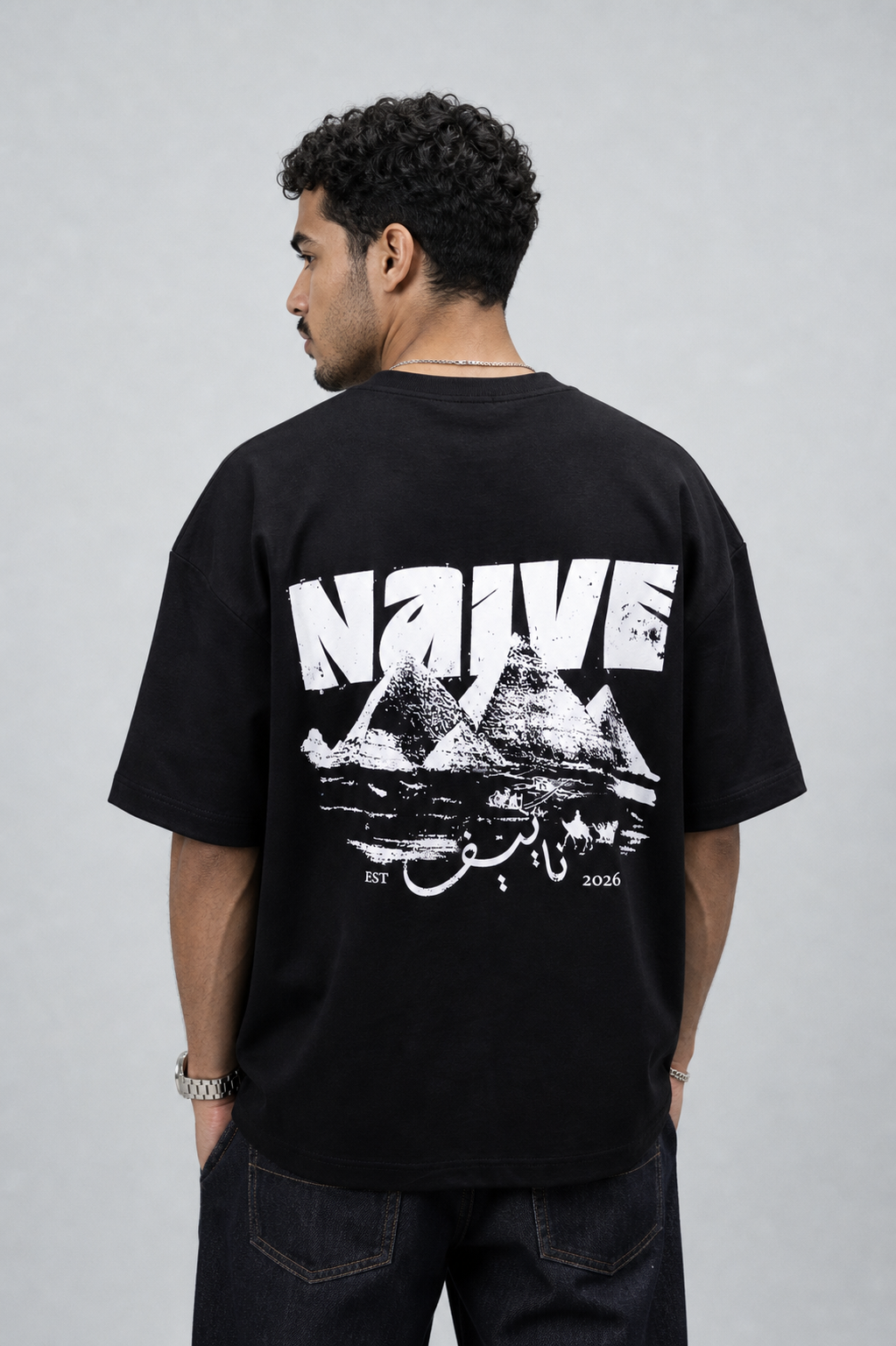 NAIVE Pyramids Black Tee - black oversized t-shirt with NAIVE x Pyramids of Giza print - back view on male model